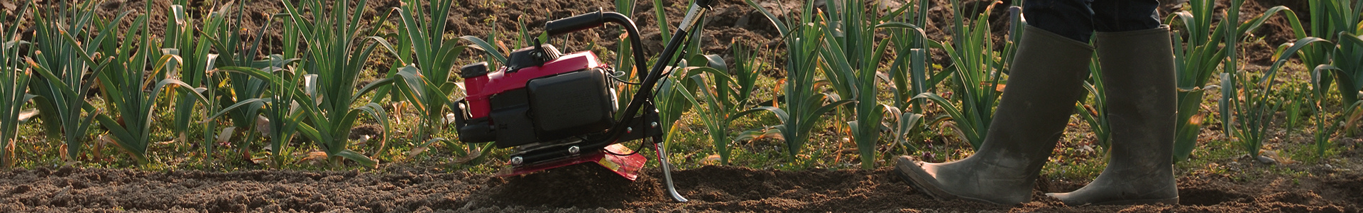 Tiller being used on soil